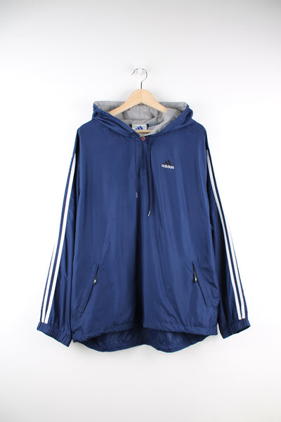 Adidas Pullover Tracksuit Jacket in a blue colourway, hooded, side pockets, and has the logo embroidered on the front and back.