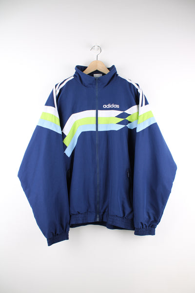 Adidas Tracksuit Jacket in a blue, white and green patterned colourway, zip up, side pockets, and has the logo embroidered on the front and back.