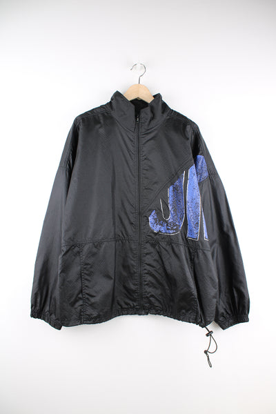Umbro Windbreaker in a black and blue colourway, zip up, side pockets, and has the logo spell out printed across the front and back.