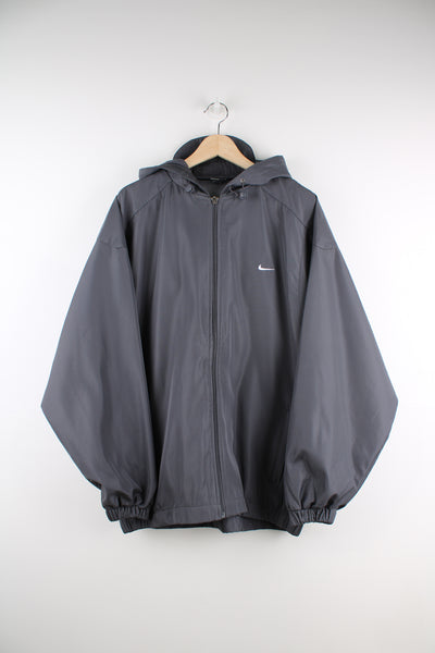Nike Air Max Lightweight Jacket in a grey colourway, zip up, hooded, side pockets, and has the logo embroidered on the front and big air max shoe design on the back.