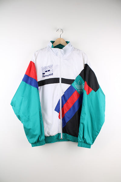 Adidas Tracksuit Jacket in a white, red, blue and green patterned colourway, zip up, side pockets, and has the logos embroidered on the front and back.