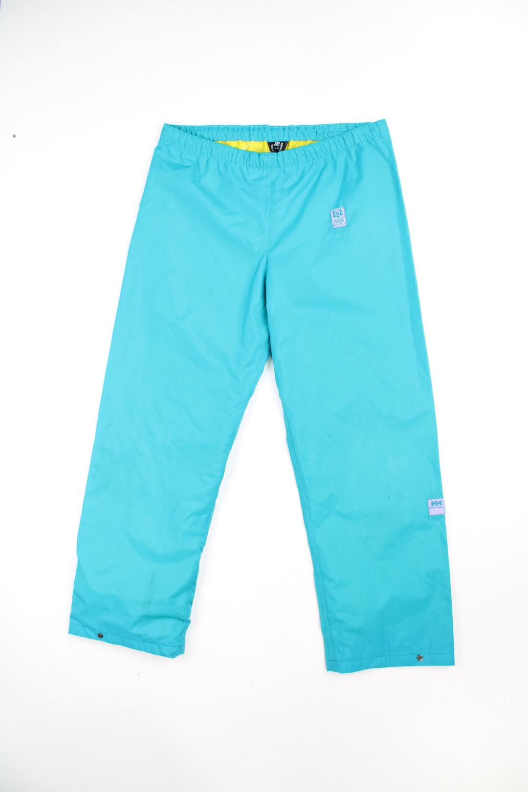 Vintage Helly Tech bright blue tech trousers by Helly Hansen, features drawstring waist and embroidered logo on the hip
