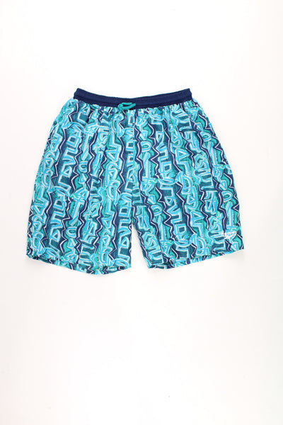 Vintage 90's Reebok blue graffiti print swim shorts with embroidered logo on the leg and elasticated/ drawstring waistband.   good condition - missing its inner net lining  Size in Label:  XL