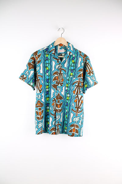 Vintage 60's Hawaiian Shirt in a blue colourway, tribal style print all over, button up with a camp collar and has a chest pocket.