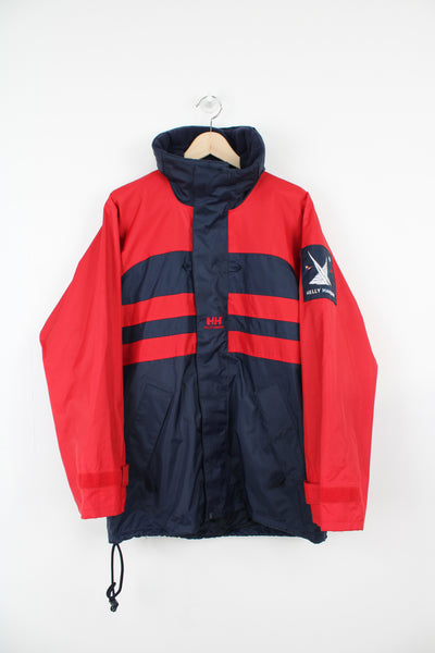 Vintage red and blue Helly Hansen Sailing waterproof jacket with embroidered logo on the chest and foldaway hood