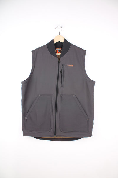 Patagonia Gilet in a grey colourway, zip up, multiple pockets, sherpa lining, and has the logo embroidered on the front.