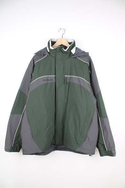Columbia Jacket in a green and grey colourway, zip up, multiple pockets, insulated lining, hooded and has the logo embroidered on the front.