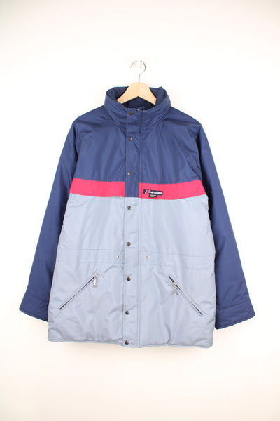 Berghaus Goretex Jacket in a blue and grey colourway, zip up, multiple pockets, hidden hood, has a insulated lining and the logo embroidered on the front.