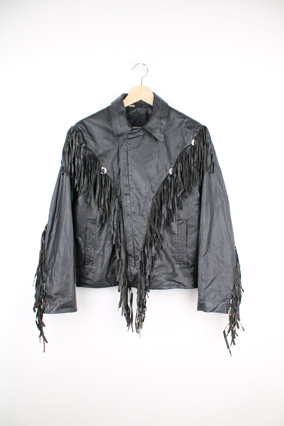 Vintage Wilson's black zip through leather jacket with fringe details on the back of the shoulders and silver conch buttons