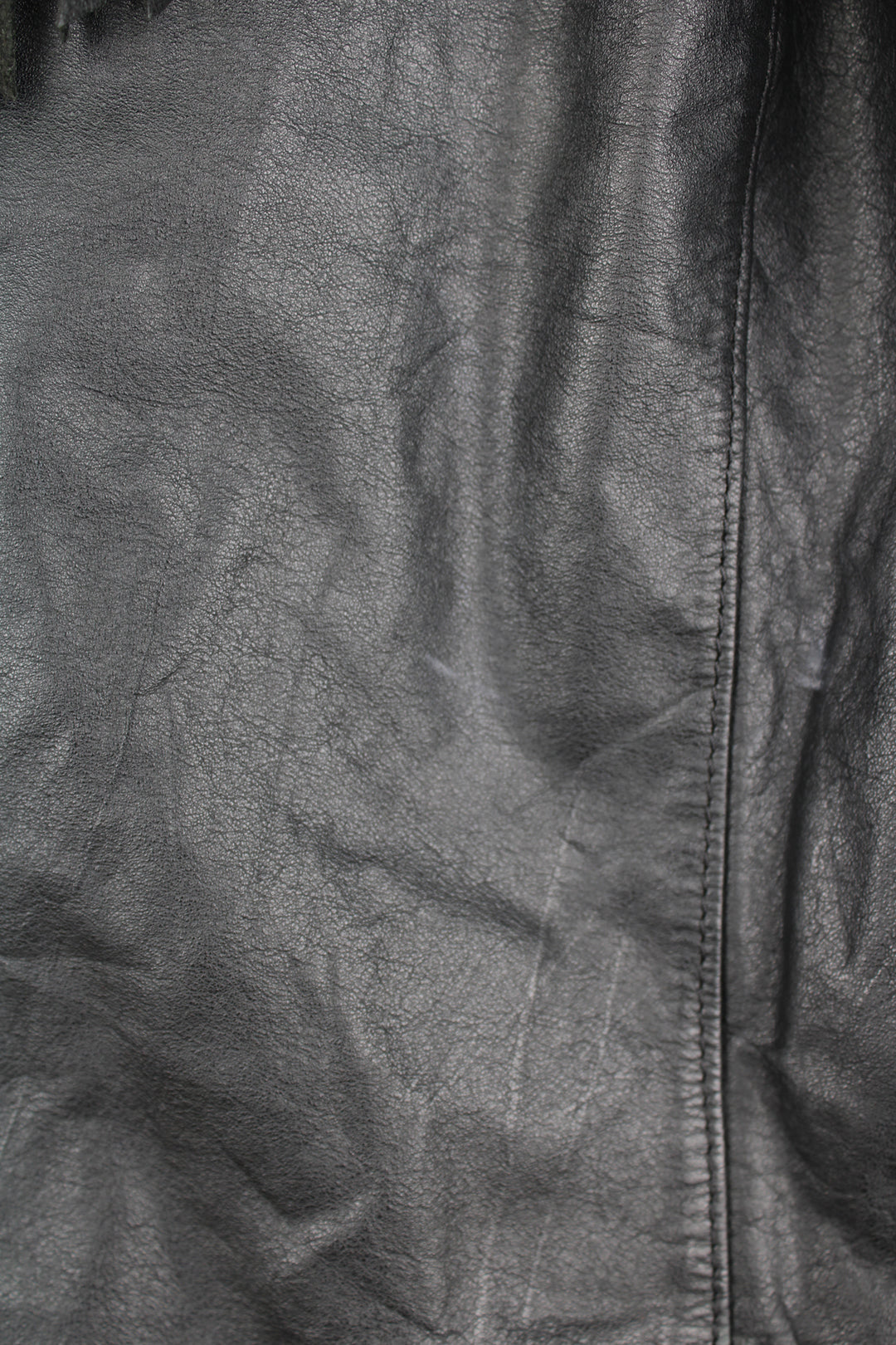 Vintage Wilson's black zip through leather jacket with fringe details on the back of the shoulders and silver conch buttons