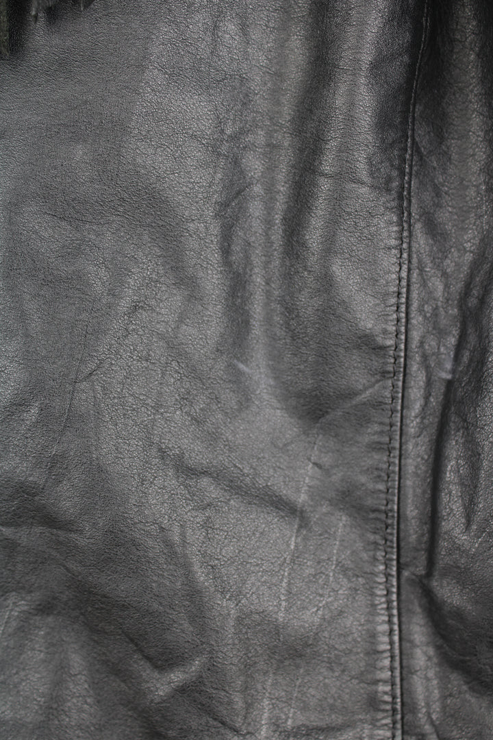 Vintage Wilson's black zip through leather jacket with fringe details on the back of the shoulders and silver conch buttons