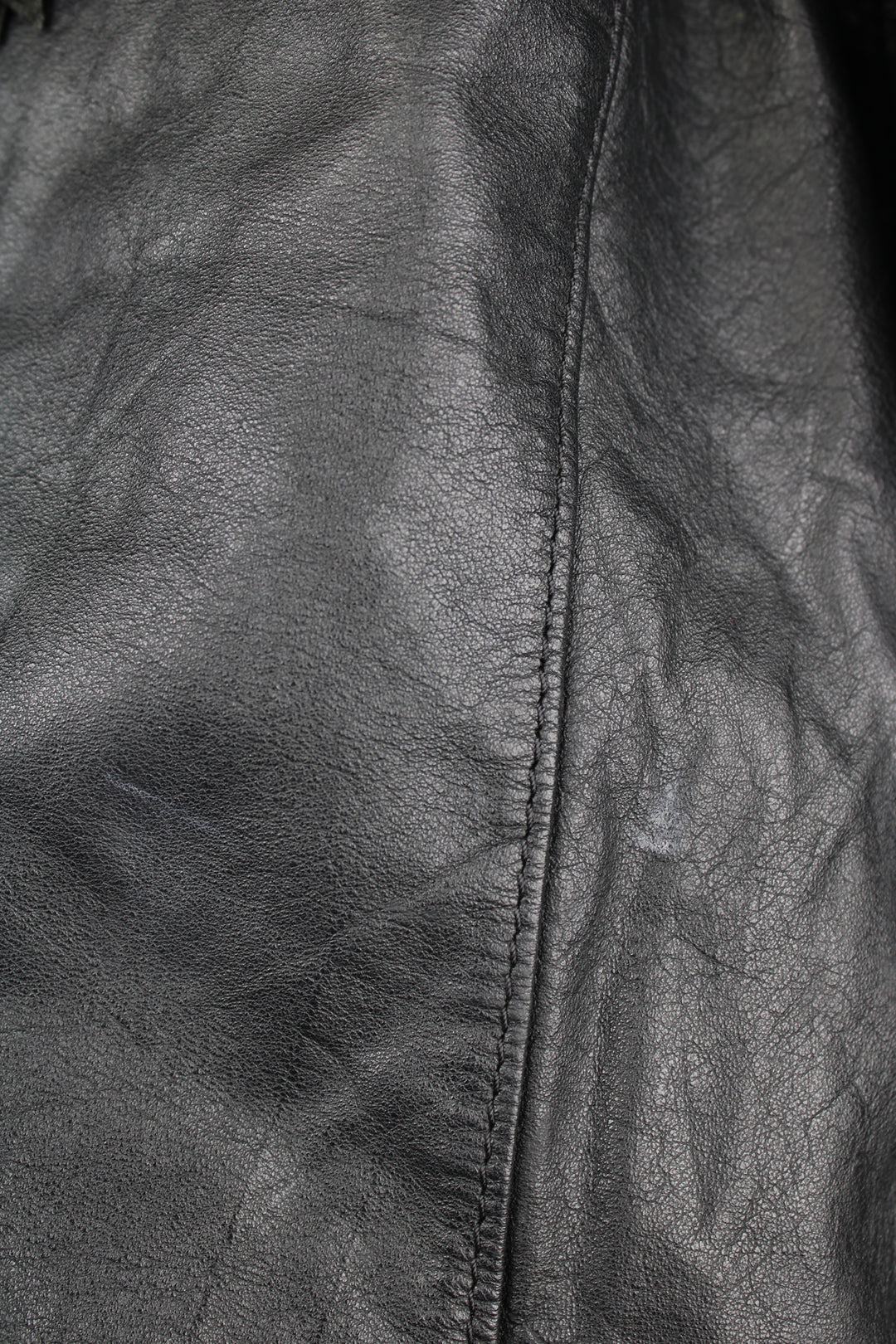 Vintage Wilson's black zip through leather jacket with fringe details on the back of the shoulders and silver conch buttons