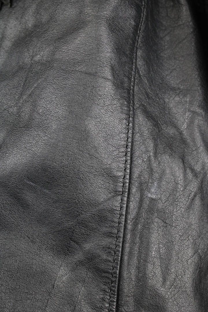 Vintage Wilson's black zip through leather jacket with fringe details on the back of the shoulders and silver conch buttons