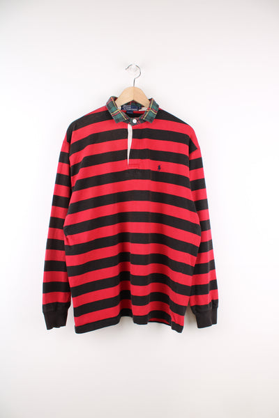 Ralph Lauren Polo Shirt in a red and black colourway with a tartan patterned collar, quarter button up, long sleeved, and has the logo embroidered on the front.