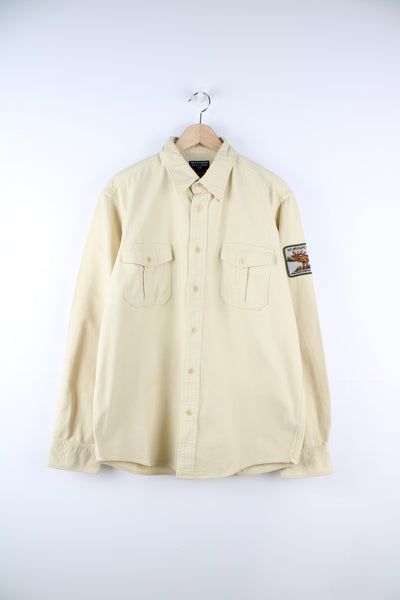 Ralph Lauren Polo Jeans Company, U.S. Wildlife Preserve Shirt in a yellow colourway, button up with double chest pockets and has a U.S. Wildlife Preserve badge embroidered on the left sleeve.