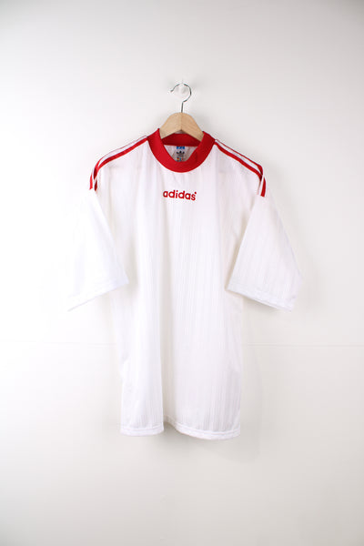 Vintage 90's Adidas football training t-shirt in white with red flocked spellout logo on the chest and three stripe detail down the arms.