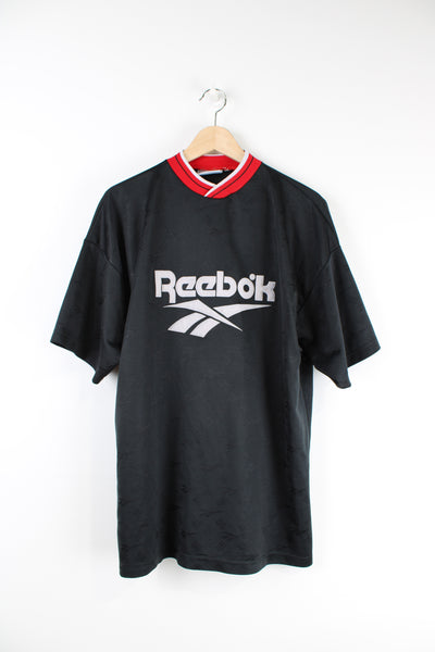 Vintage 90's Reebok sports T-shirt in black with spell-out Reebok logo across the front. 