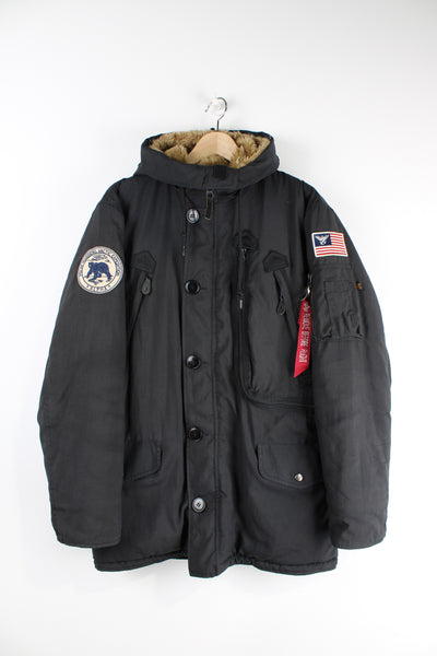 Vintage Alpha Industries black parka coat, features multiple pockets, faux fur lined hood and embroidered badge on the shoulder