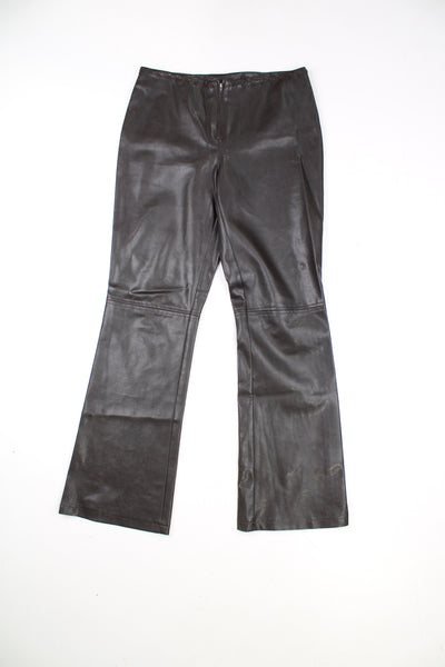 Vintage Leather Trousers in a brown colourway, mid rise, and has cross stitching design going around the waist and down the side of the legs.