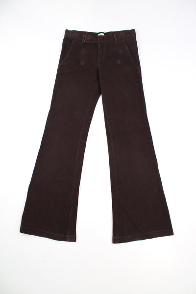 Calvin Klein Flared Corduroy Trousers in a brown colourway, low rise, side pockets, adjustable waist, and has the logo embroidered on the back.