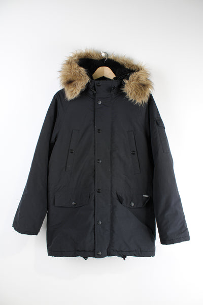 Vintage Carhartt black parka jacket with quilted lining, fur hood and multiple pockets.