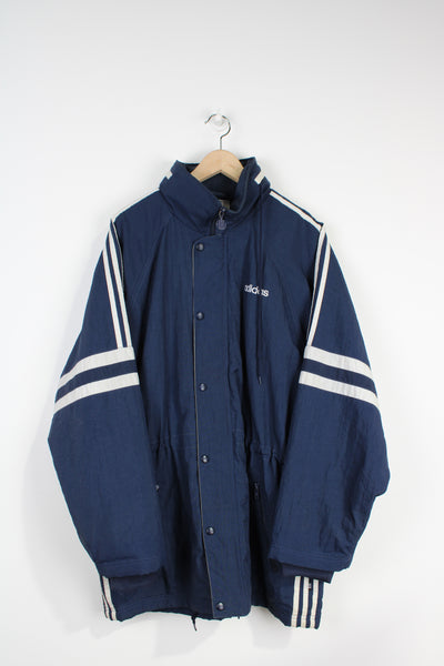 Vintage 90's navy blue Adidas padded sports coat, with embroidered logo on the chest and three stripes down the sleeve 