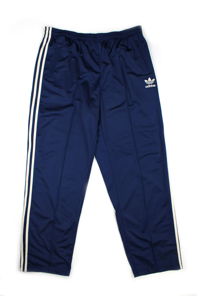 Vintage 00's Adidas blue pintucked tracksuit bottoms white stripes down the side, embroidered logo, and has a elasticated waist.