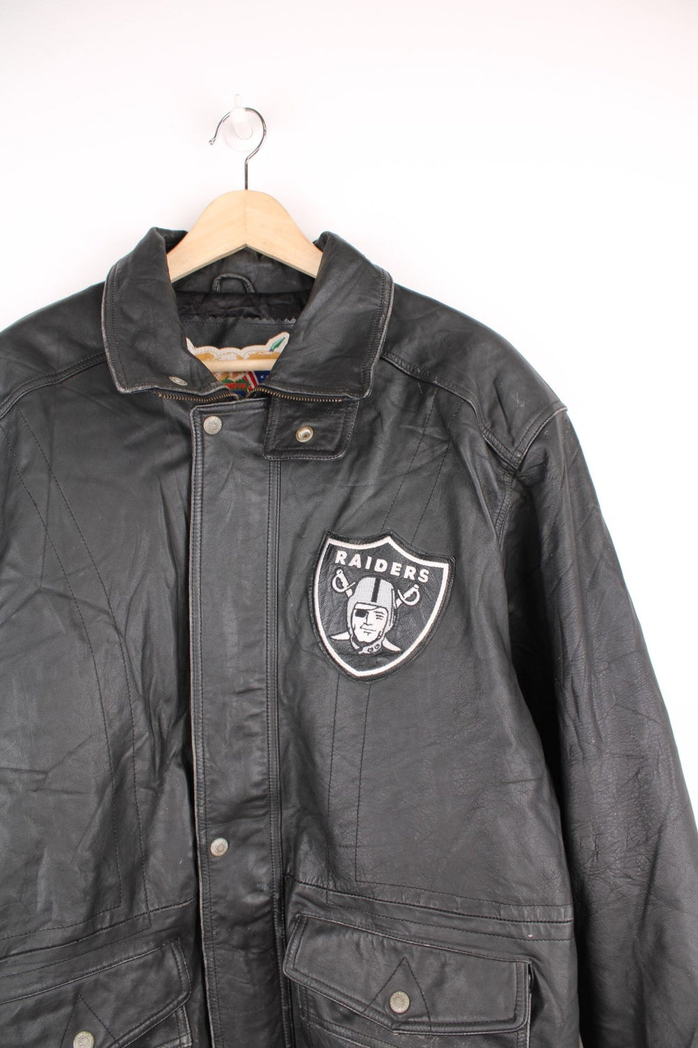 Vintage Oakland Raiders collared zip through leather jacket. Features embroidered badge on the front and back.