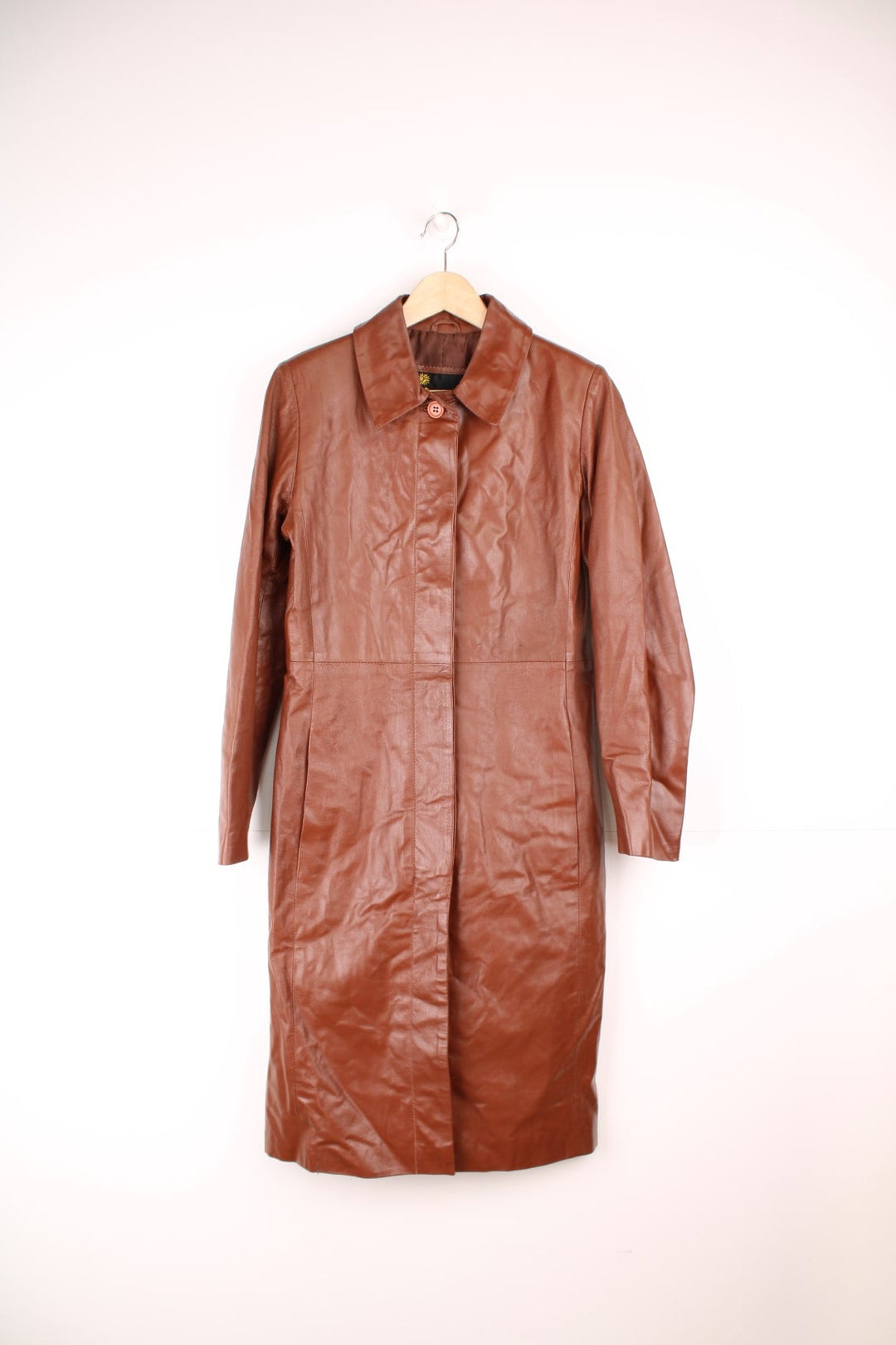 Paragon red-brown leather trench coat with two side slit pockets and concealed button closure.