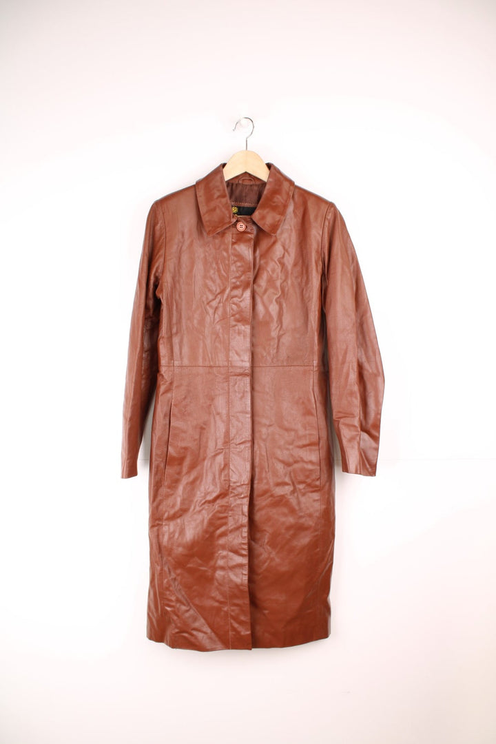 Paragon red-brown leather trench coat with two side slit pockets and concealed button closure.