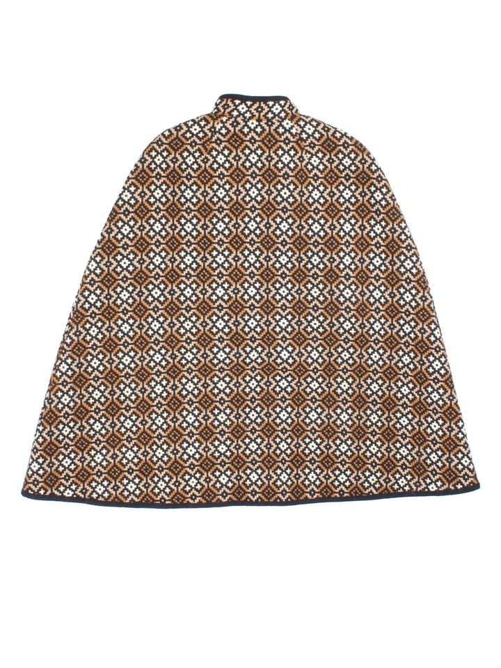 Vintage Welsh Woolen cape in a brown, white and black patterned colourway. Buttons up neckline and is fully lined. Classic double split and belt fastening.