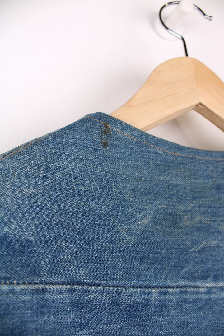 Vintage Levi Strauss waistcoat in a mixed denim blue colourway. The waistcoat was made in the 1970s and is part of a Levi's line Fresh Produce. It has a small patch pocket on the front, and a waist fastener on the back. Made in the USA.