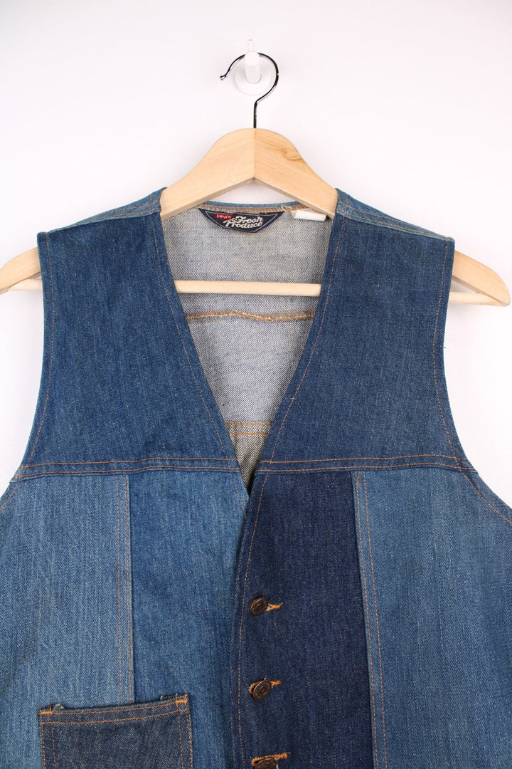 Vintage Levi Strauss waistcoat in a mixed denim blue colourway. The waistcoat was made in the 1970s and is part of a Levi's line Fresh Produce. It has a small patch pocket on the front, and a waist fastener on the back. Made in the USA.