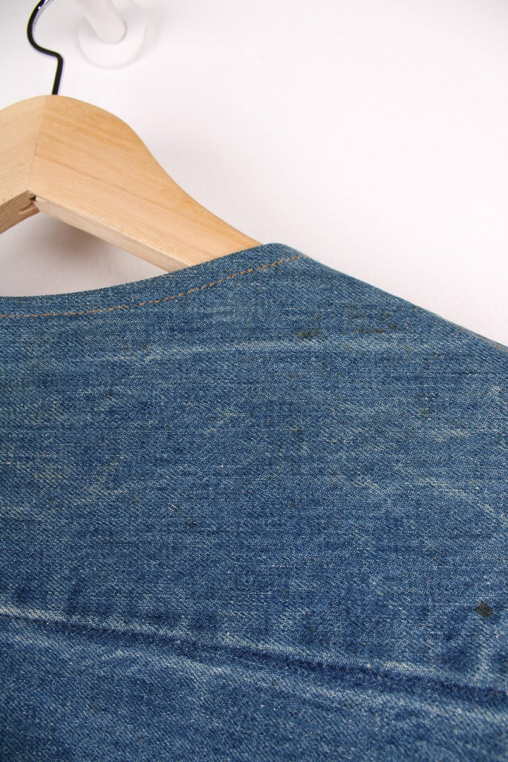 Vintage Levi Strauss waistcoat in a mixed denim blue colourway. The waistcoat was made in the 1970s and is part of a Levi's line Fresh Produce. It has a small patch pocket on the front, and a waist fastener on the back. Made in the USA.
