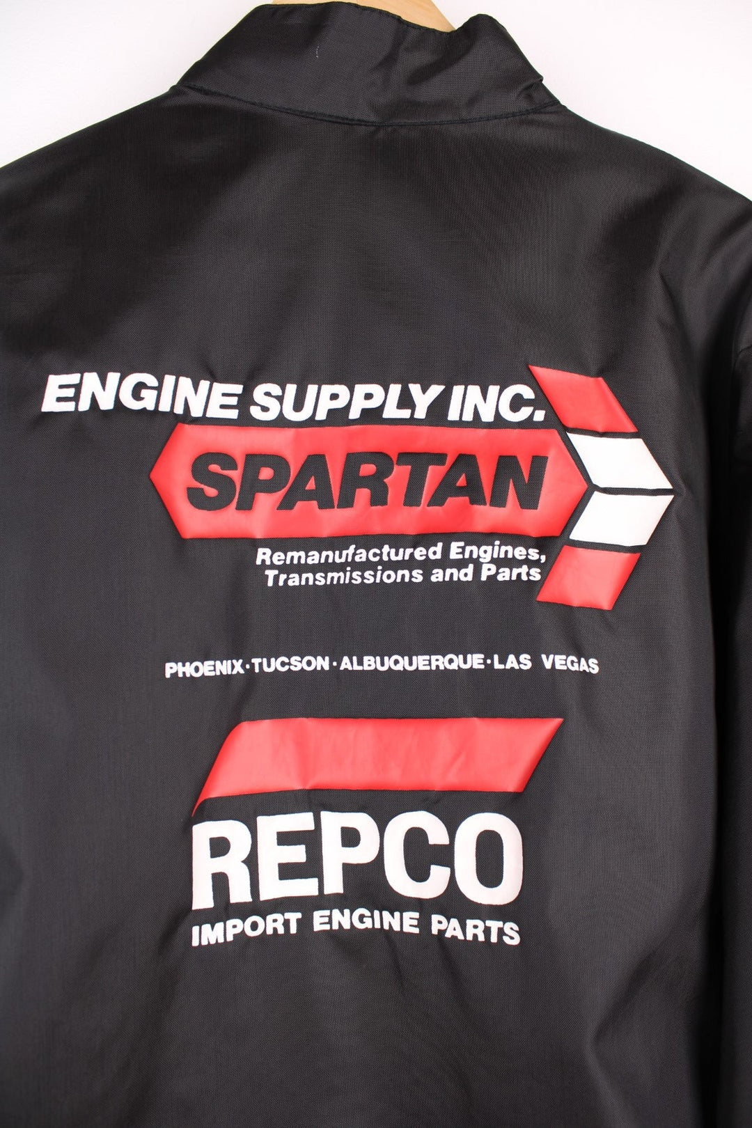 Vintage shell jacket in a black colourway. The jacket has a large printed logo on the back, and from the manufacturing of the jacket seems to date from the late 70s early 80s. Made in the USA.