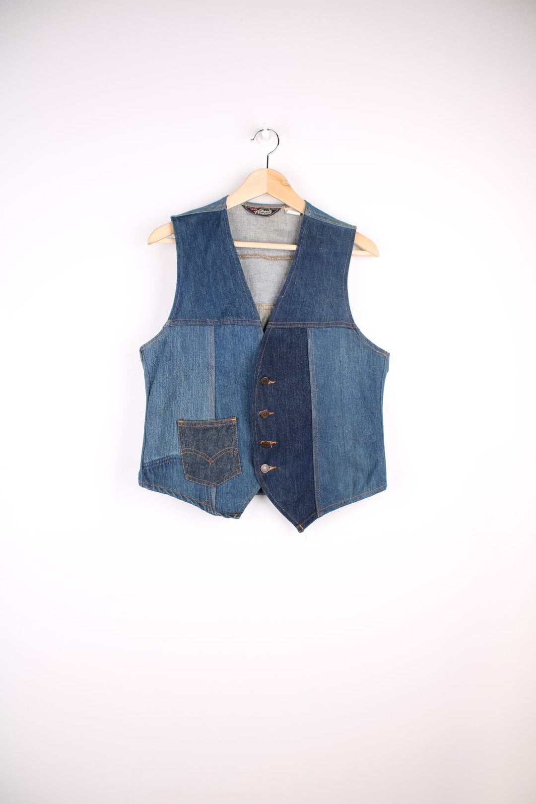 Vintage Levi Strauss waistcoat in a mixed denim blue colourway. The waistcoat was made in the 1970s and is part of a Levi's line Fresh Produce. It has a small patch pocket on the front, and a waist fastener on the back. Made in the USA.