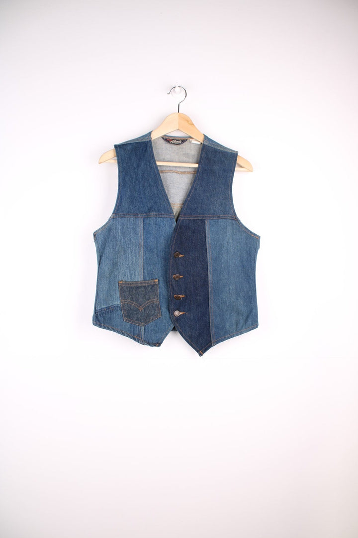 Vintage Levi Strauss waistcoat in a mixed denim blue colourway. The waistcoat was made in the 1970s and is part of a Levi's line Fresh Produce. It has a small patch pocket on the front, and a waist fastener on the back. Made in the USA.