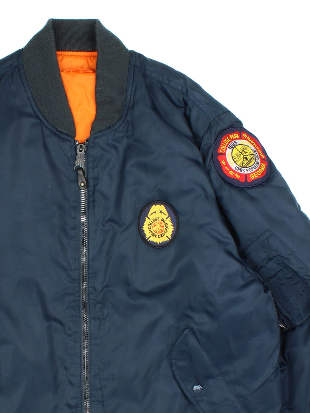 Vintage College Park Fire Department MA1 Reversible Bomber Jacket in either a blue or orange colourway options. Zips up and has side pockets, insulated, and has badge logos embroidered on the front and sleeves.