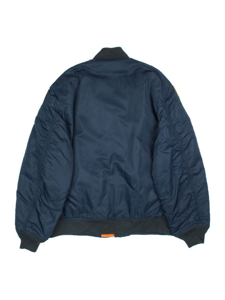 Vintage College Park Fire Department MA1 Reversible Bomber Jacket in either a blue or orange colourway options. Zips up and has side pockets, insulated, and has badge logos embroidered on the front and sleeves.