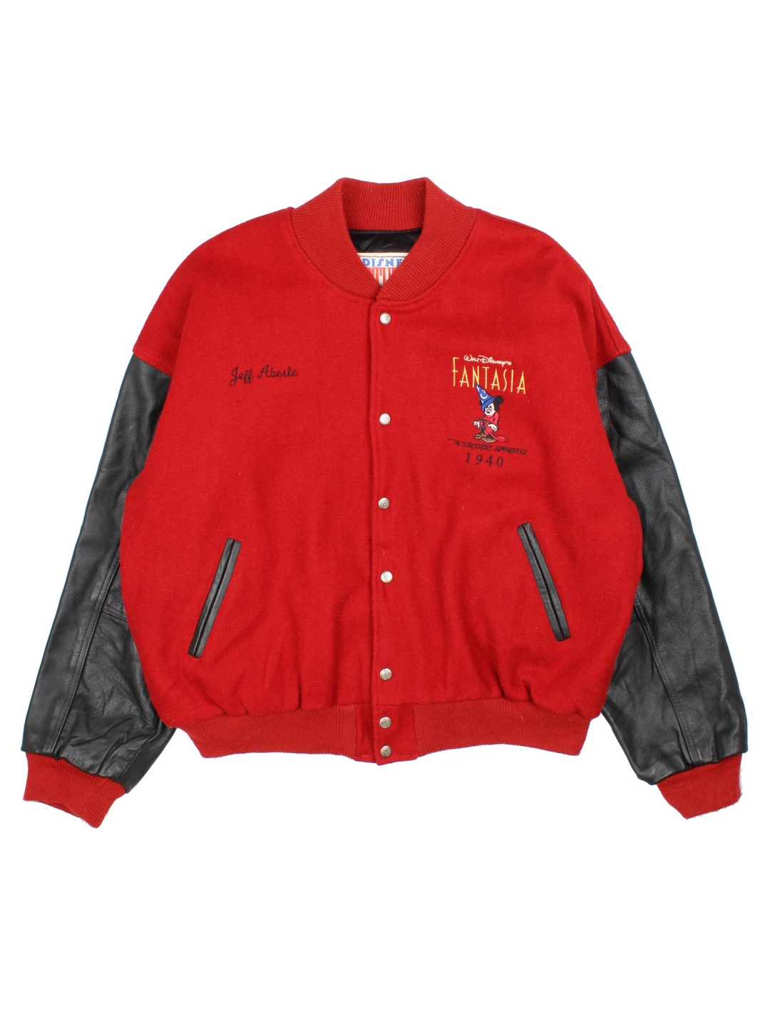 1940 Fantasia Disney Studios Bomber Jacket in a red colourway with black leather panelling on the sleeves. Buttons up and has side pockets, insulated with a quilted lining, and has the logos embroidered on the front, with large graphic on the back.