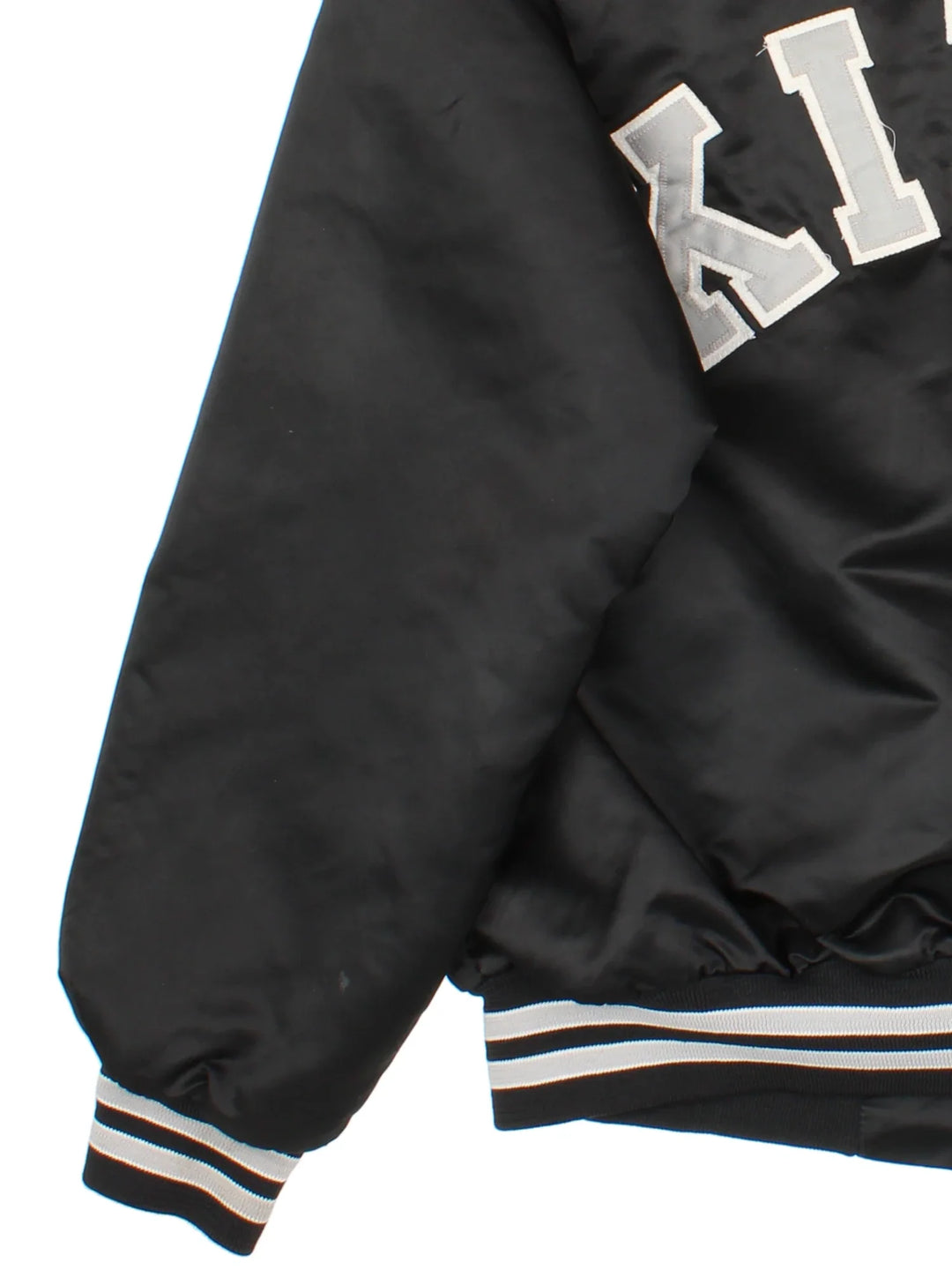 Vintage Los Angeles Kings Varsity Jacket in a black/white colourway. Buttons up with side pockets, contrast cuffs and hem. Logos embroidered on front and back.