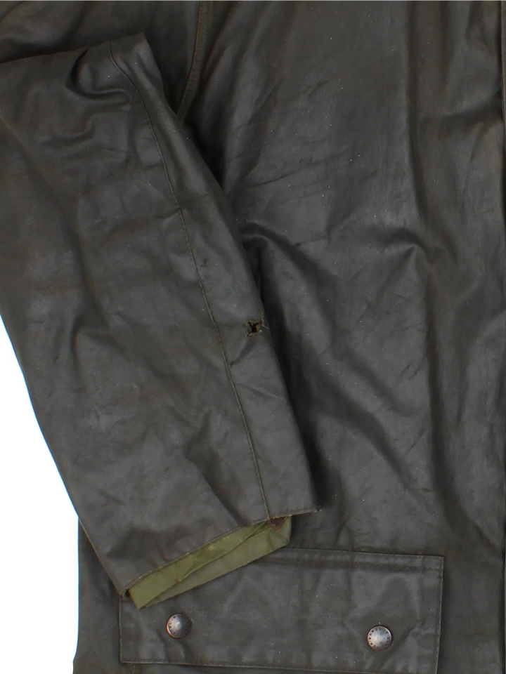 Barbour Northumbria Wax Jacket in a green colourway. Zip/button fastening, with multiple pockets, cord collar detail and checked lining.