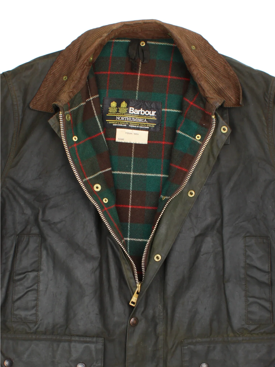 Barbour Northumbria Wax Jacket in a green colourway. Zip/button fastening, with multiple pockets, cord collar detail and checked lining.