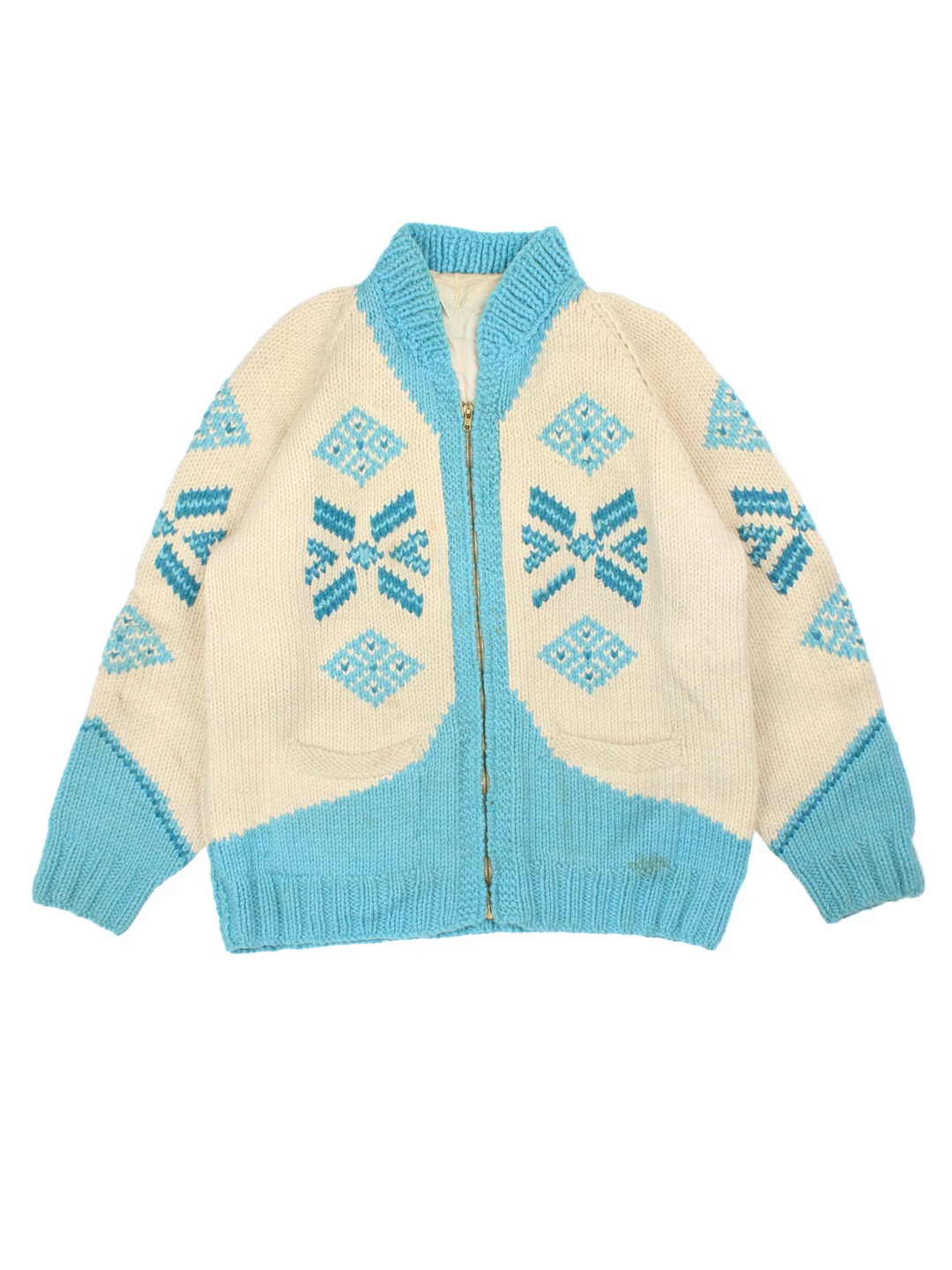 Vintage 80's Snowflake Cowichan Knitted Sweater in a tan and blue colourway with snowflake patterns all over, zip up closure and has double front pockets.