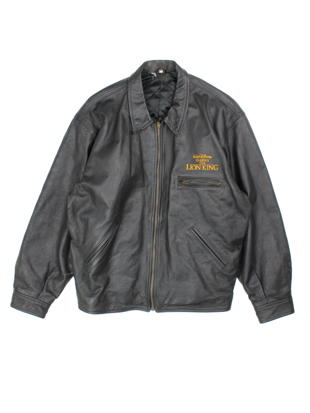 Vintage 1994 Disney Lion King Promo Leather Jacket in black. The jacket has a dagger collar, Lion King logo embroidered on the front panel and an interior pocket. The jacket is also lined with a quilted satin fabric.