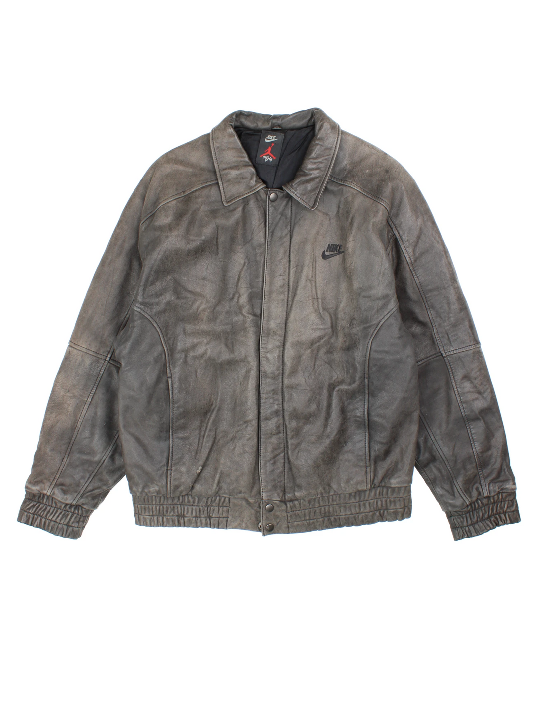 Vintage Nike Flight Air Jordan bomber jacket in brown. The jacket has the nike logo embroidered in black on the front, a large embroidered logo on the back, a zip to close and an interior pocket.
