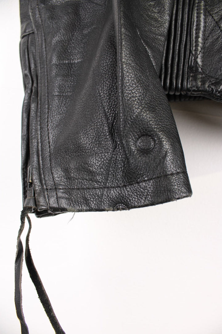 Harley Davidson Motorcycle Jacket in a black colourway, zip up with side pockets, has adjustable waistline buckles, air vent zip on the back, mesh lining, and the logo embroidered on the front and spell out on the back.