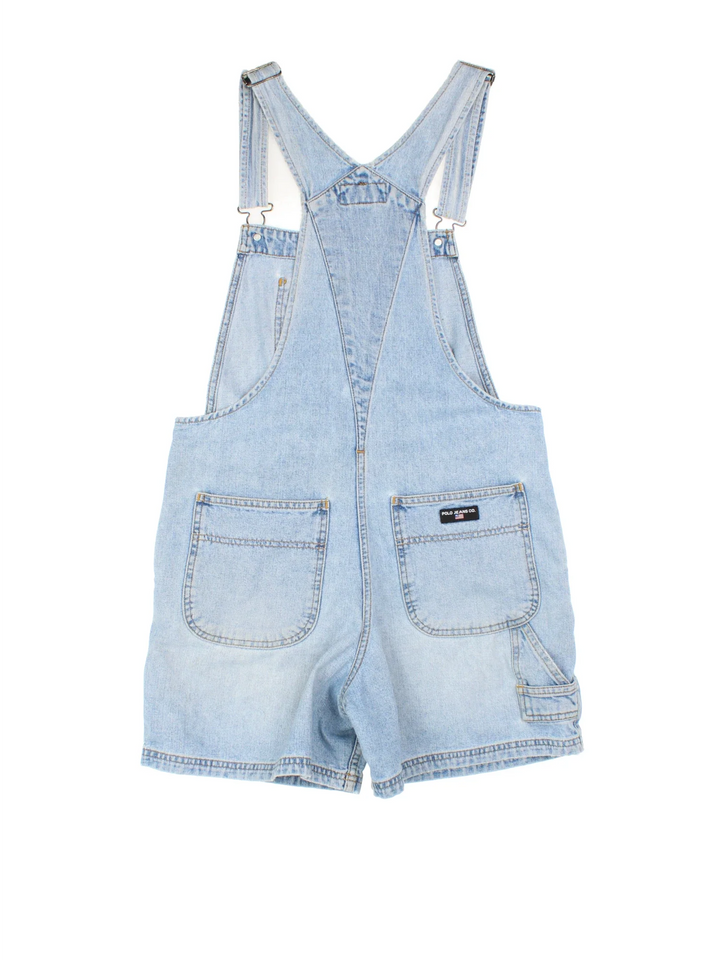 Ralph Lauren Short Dungarees in blue colourway with multiple pockets, adjustable straps and the logo embroidered on the front/back.