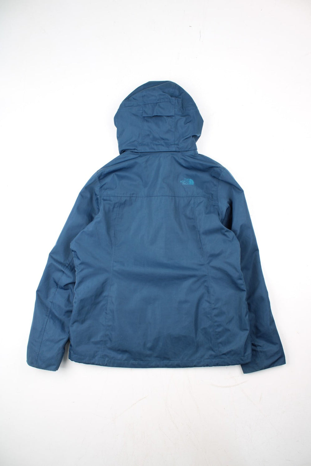 The North Face Dryvent Jacket in a blue colourway. Zips up and has multiple pockets, hooded, and has the logo printed on the front and back.