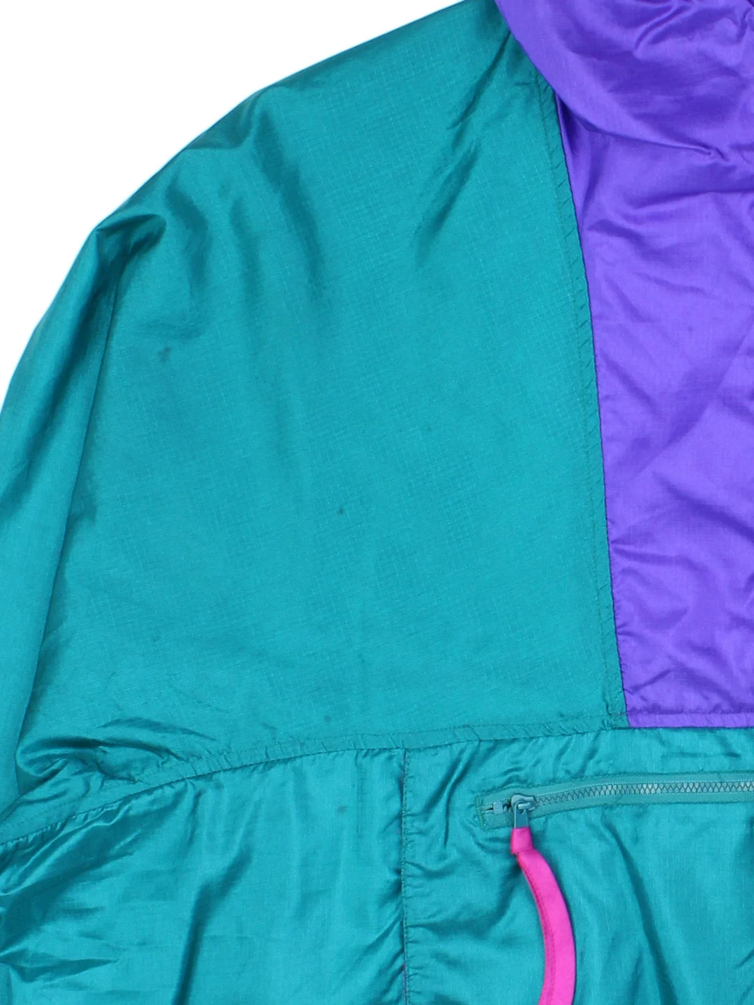 Vintage 90's Columbia Windbreaker Jacket in a green/purple colourway. 1/4 zip fastening, hooded and has large front pocket. Drawstring hem and has the logo embroidered on the front.